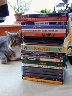 Red sits by DVD stack.